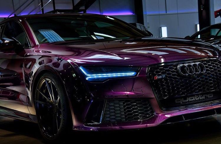 Close-up of an Audi RS front end and Matrix LED headlight in purple light